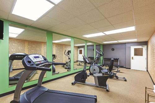 a gym with several treadmills and elliptical machines at La Quinta by Wyndham Granbury in Granbury