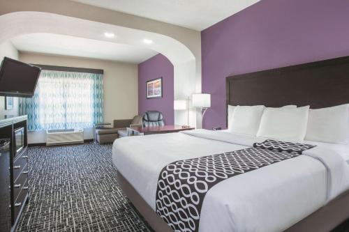 a hotel room with a large bed and a television at La Quinta by Wyndham Fort Walton Beach in Fort Walton Beach
