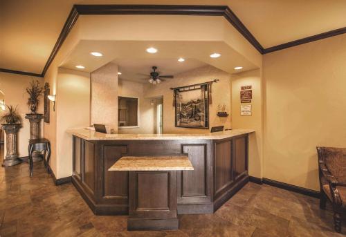 a bar in a home with a large mirror at La Quinta by Wyndham Marble Falls in Marble Falls