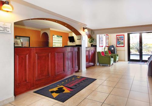 
a room with a red carpet and a blue floor at La Quinta Inn by Wyndham Orlando International Drive North in Orlando
