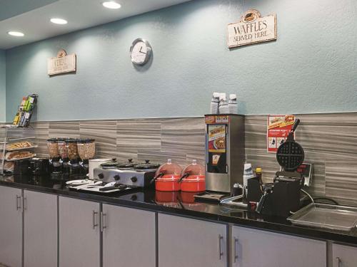 a restaurant kitchen with a counter top with a counter top at La Quinta by Wyndham Slidell - North Shore Area in Slidell