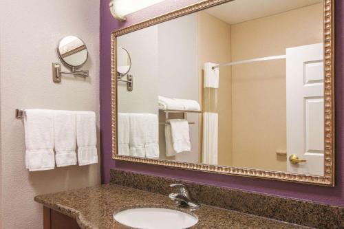 a bathroom with a sink and a mirror at La Quinta by Wyndham Gainesville in Gainesville