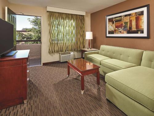 a living room with a couch and a tv at Mission View Inn & Suites San Diego Sea World - Zoo in San Diego