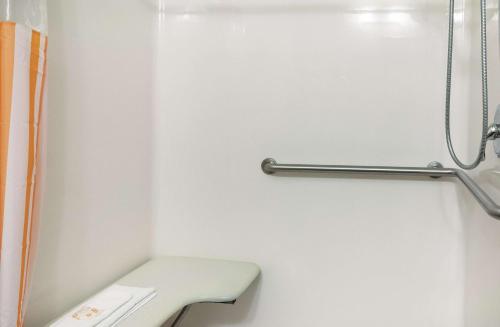 a bathroom with a toilet and a shower curtain at La Quinta by Wyndham Houma in Houma