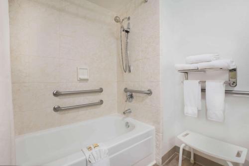 a bathroom with a white tub and a sink at La Quinta Inn by Wyndham Everett in Everett