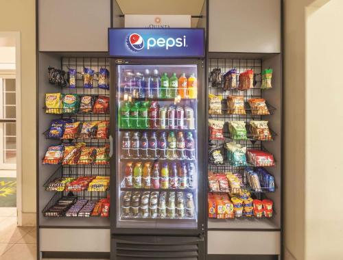 a soda vending machine in a store with drinks at La Quinta by Wyndham Angleton in Angleton