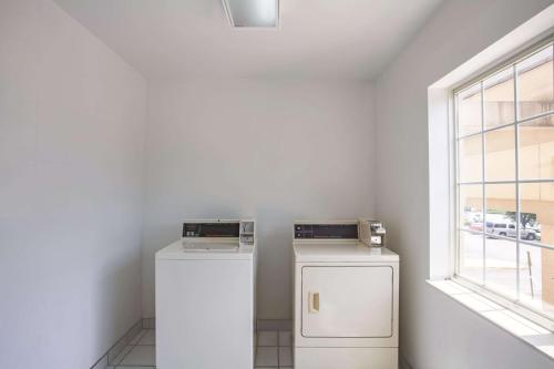 a washer and dryer in a room with a window at La Quinta Inn by Wyndham Richmond South in Chester