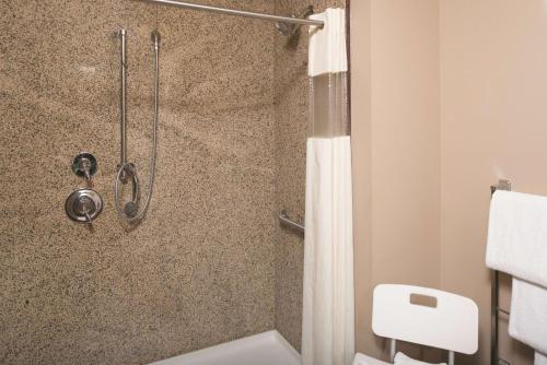 a bathroom with a shower with a shower curtain at La Quinta by Wyndham Bozeman in Bozeman