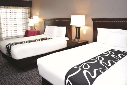 two beds in a hotel room next to each other at La Quinta by Wyndham Abilene Mall in Abilene