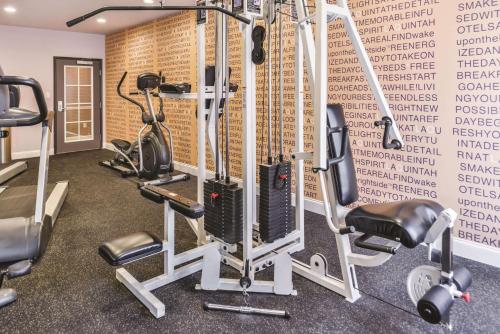 a gym with tread machines and a wall withcriptions at La Quinta by Wyndham Abilene Mall in Abilene