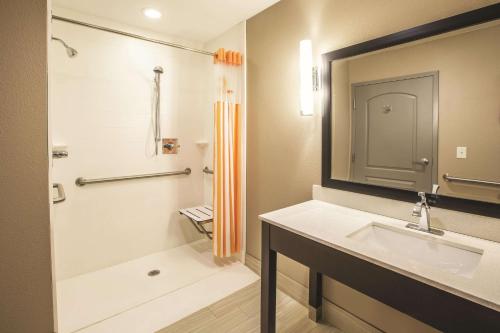 a bathroom with a sink and a shower at La Quinta by Wyndham Hattiesburg - I-59 in Hattiesburg