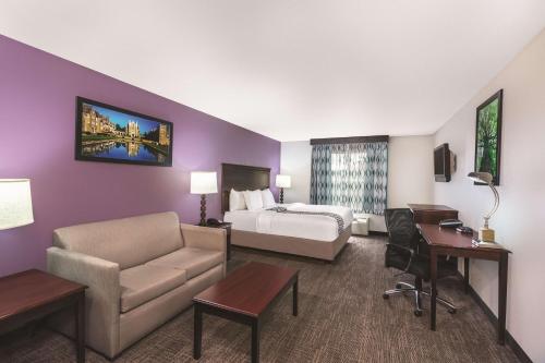 una camera d'albergo con un letto, un divano e una scrivania di La Quinta by Wyndham Rome a Rome