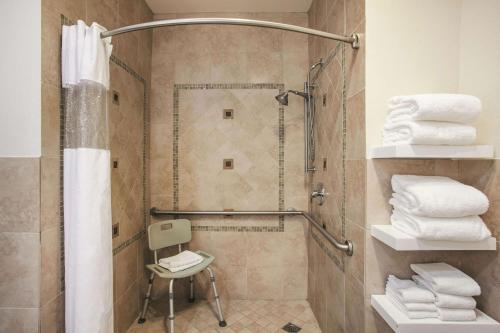 a bathroom with a shower with white towels at La Quinta by Wyndham Dublin - Pleasanton in Dublin