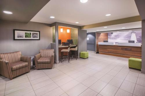 a waiting room at a hospital with chairs and a bed at La Quinta by Wyndham Erie in Erie