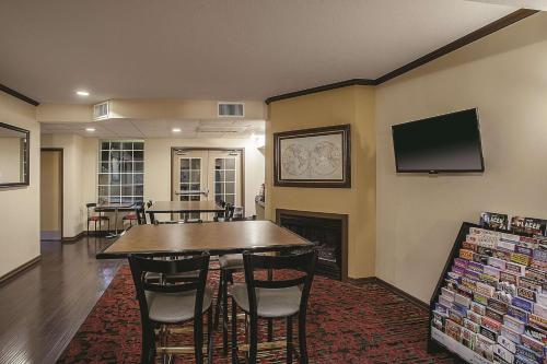 a dining room with a table and chairs and a tv at La Quinta by Wyndham Davis in Davis