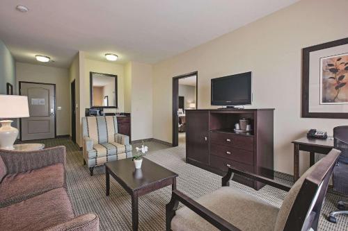 a living room with a couch and a tv at La Quinta by Wyndham DFW Airport West - Euless in Euless