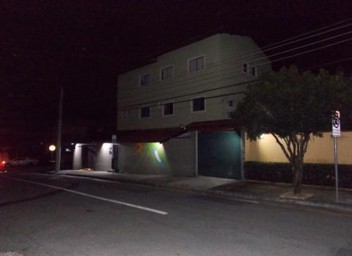 a building with a light on the side of it at night at Hostel São José Dos Campos in São José dos Campos