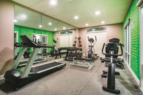 a gym with treadmills and machines in a room at La Quinta by Wyndham Russellville in Russellville