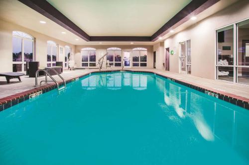 a swimming pool in a house with a large swimming pool at La Quinta by Wyndham Russellville in Russellville