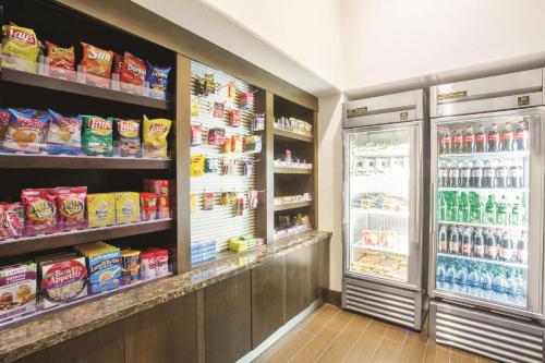 a grocery store aisle with a refrigerator and food at La Quinta by Wyndham Conference Center Prescott in Prescott