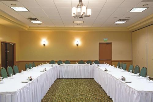 a large meeting room with a long table with chairs at La Quinta by Wyndham Salisbury in Salisbury