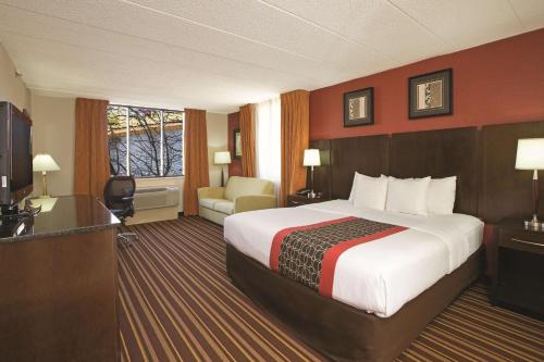 a hotel room with a large bed and a television at La Quinta by Wyndham Salisbury in Salisbury