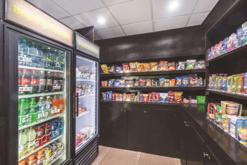 a grocery store with a refrigerator and lots of drinks at La Quinta Inn & Suites by Wyndham Louisville East in Louisville