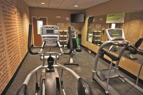 a gym with two exercise bikes and a treadmill at La Quinta by Wyndham Edmond in Edmond