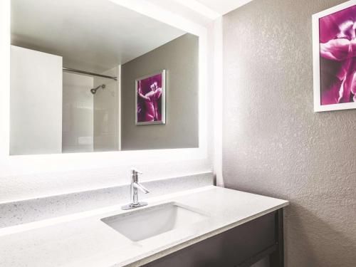 a bathroom with a sink and a mirror at La Quinta by Wyndham Cincinnati Sharonville in Sharonville