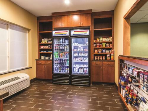 a refrigerator in a grocery store filled with drinks at La Quinta by Wyndham Fargo-Medical Center in Fargo