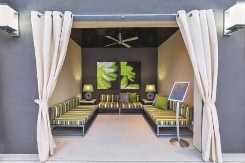 a waiting room with couches and curtains at La Quinta by Wyndham Rockport - Fulton in Rockport
