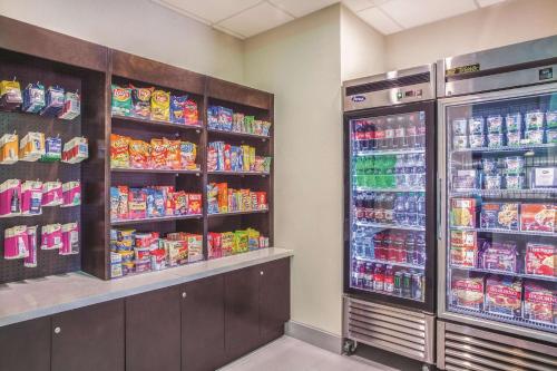a grocery store aisle with two refrigerators at La Quinta by Wyndham Cullman in Cullman