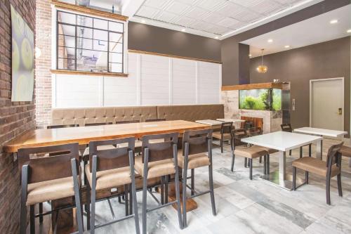 a dining room with a long table and chairs at La Quinta by Wyndham Inner Harbor Downtown in Baltimore