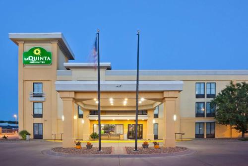 a front view of a hotel with a sign on it at La Quinta by Wyndham Salina in Salina