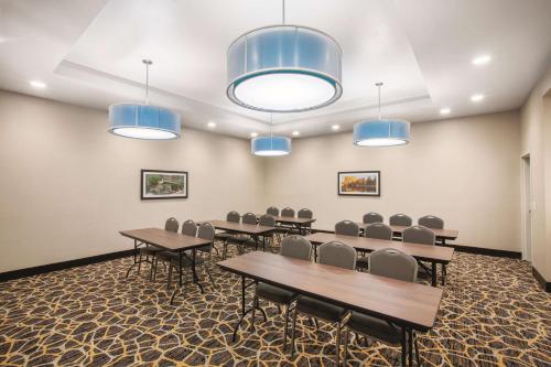 a conference room with tables and chairs and blue lights at La Quinta by Wyndham Tulsa Broken Arrow in Broken Arrow
