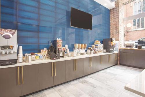 a kitchen with a counter with a television on it at La Quinta by Wyndham Inner Harbor Downtown in Baltimore