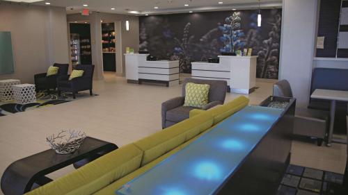a lobby with a couch and chairs in a store at La Quinta by Wyndham Odessa North - Sienna Tower in Odessa