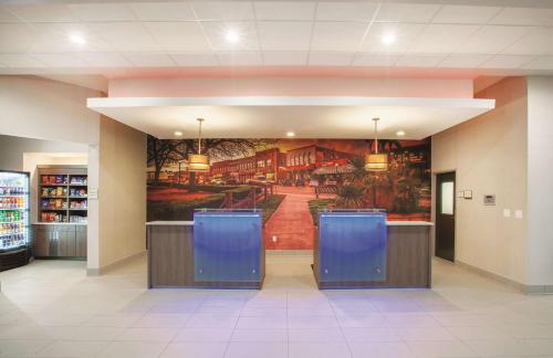 a lobby with a large painting on the wall at La Quinta by Wyndham San Marcos Outlet Mall in San Marcos