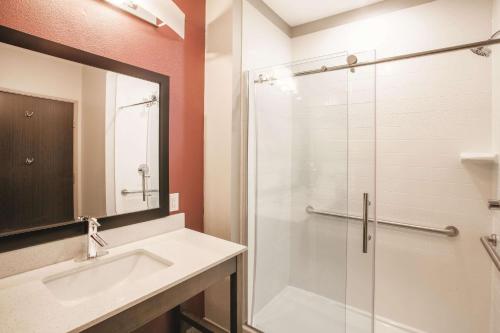 a bathroom with a sink and a shower at La Quinta by Wyndham San Marcos Outlet Mall in San Marcos