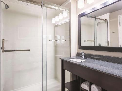 a bathroom with a glass shower and a sink at La Quinta Inn & Suites by Wyndham Walla Walla in Walla Walla