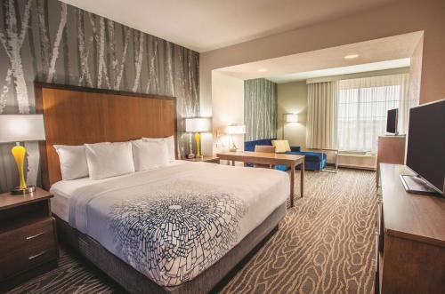 a hotel room with a bed and a desk at La Quinta by Wyndham Duluth in Duluth