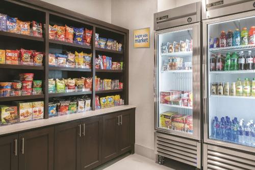 a grocery store with a refrigerator and lots of food at La Quinta by Wyndham Fort Worth West - I-30 in Fort Worth