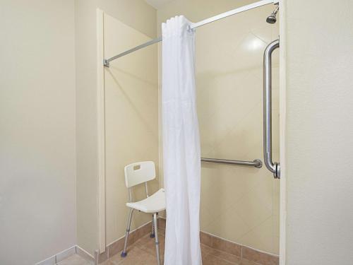 a shower with a white shower curtain in a bathroom at La Quinta by Wyndham Mathis in Mathis
