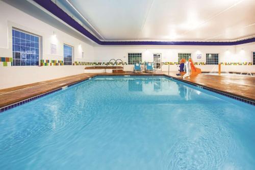 a large swimming pool with blue water at La Quinta by Wyndham St. Paul-Woodbury in Woodbury
