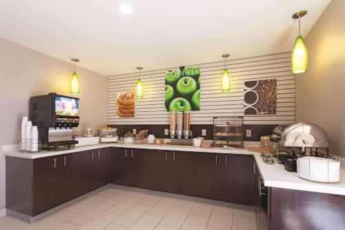a restaurant kitchen with a counter with aperature at La Quinta by Wyndham Knoxville North I-75 in Knoxville