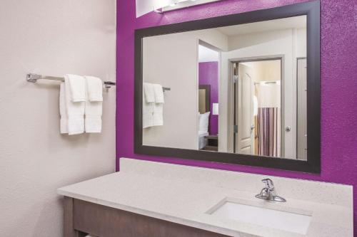 a bathroom with a sink and a mirror at La Quinta by Wyndham Effingham in Effingham