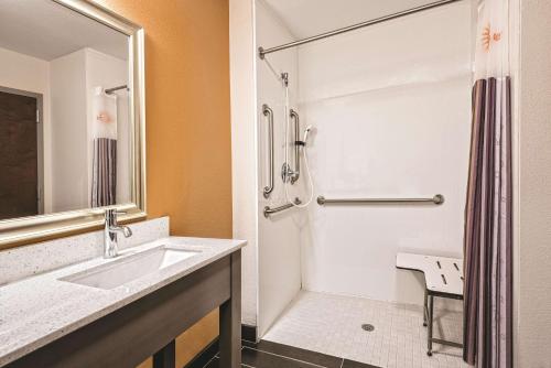 a bathroom with a sink and a shower at La Quinta by Wyndham San Antonio by Frost Bank Center in San Antonio