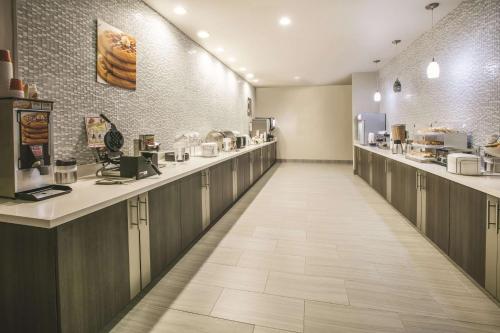 a restaurant with a long corridor with aasteryasteryasteryasteryasteryasteryasteryastery at La Quinta by Wyndham Dallas - Richardson in Dallas