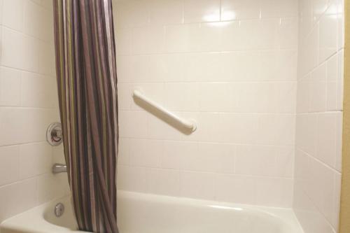 a bathroom with a shower with a shower curtain at La Quinta I-95 Deerfield Beach - Next to The Home Depot & Behind The Wawa in Deerfield Beach