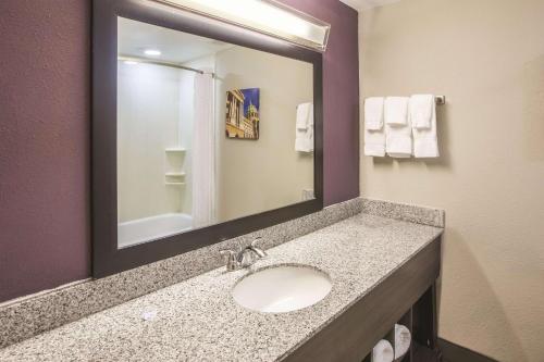 a bathroom with a sink and a mirror at La Quinta by Wyndham Mechanicsburg - Harrisburg in Mechanicsburg